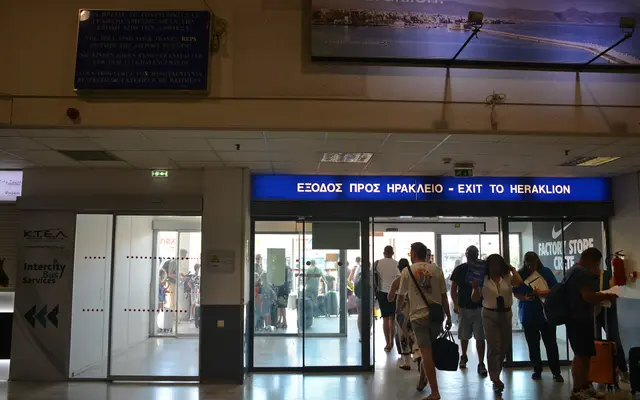 “Exit to Heraklion” doors inside Heraklion Airport arrivals hall