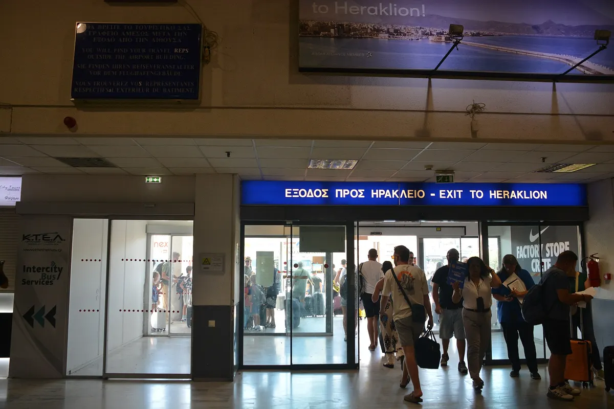 “Exit to Heraklion” doors inside Heraklion Airport arrivals hall