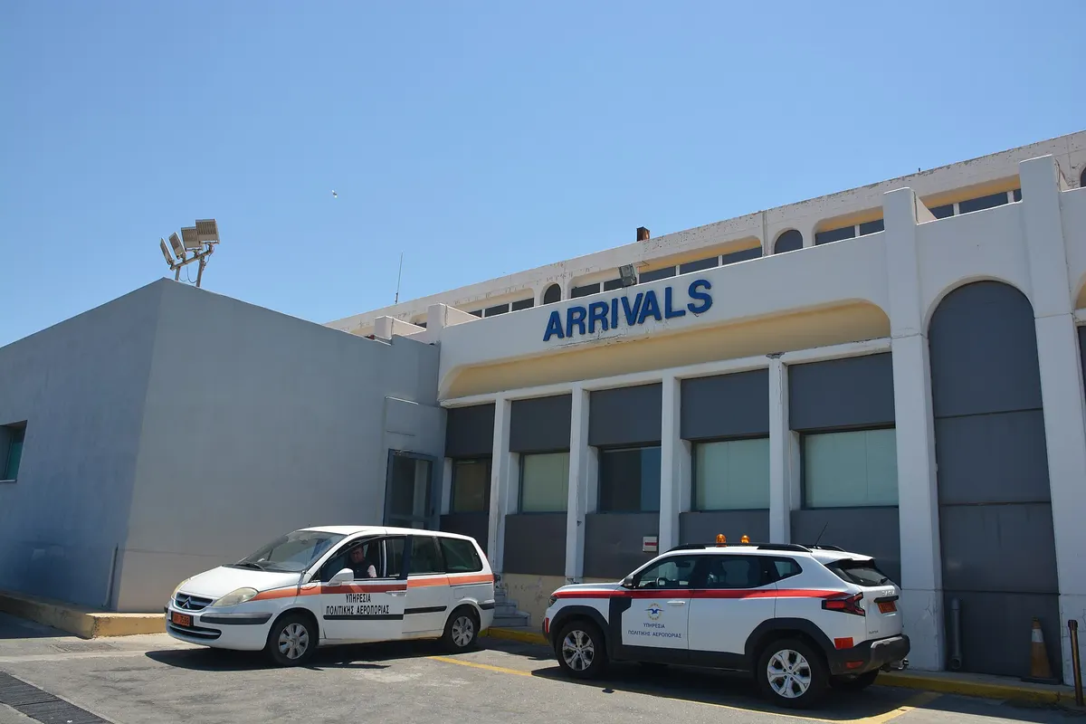 Arrivals entrance of Heraklion Airport, with the ARRIVALS sign above the doors